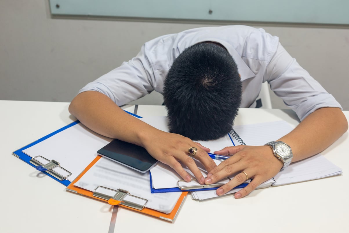 Exhausted man feeling stucked with report he dealing with